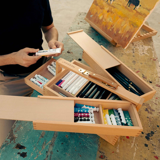 Artist selecting supplies from the open MEEDEN three-level storage box