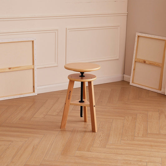 Artist seated on the MEEDEN beech drafting stool