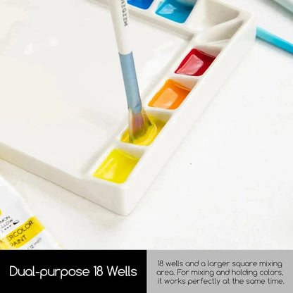 Paint brush loading colour from a well in the MEEDEN porcelain palette