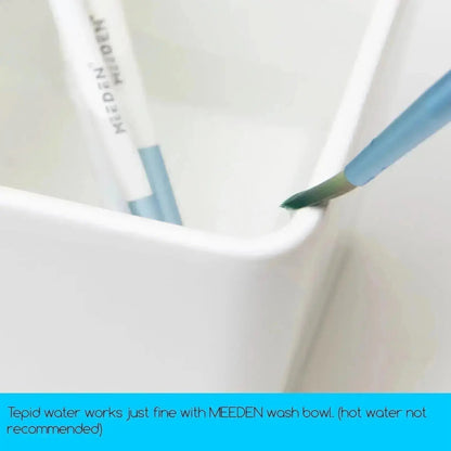 Paint brush rinsing inside one well of the MEEDEN ceramic wash bowl