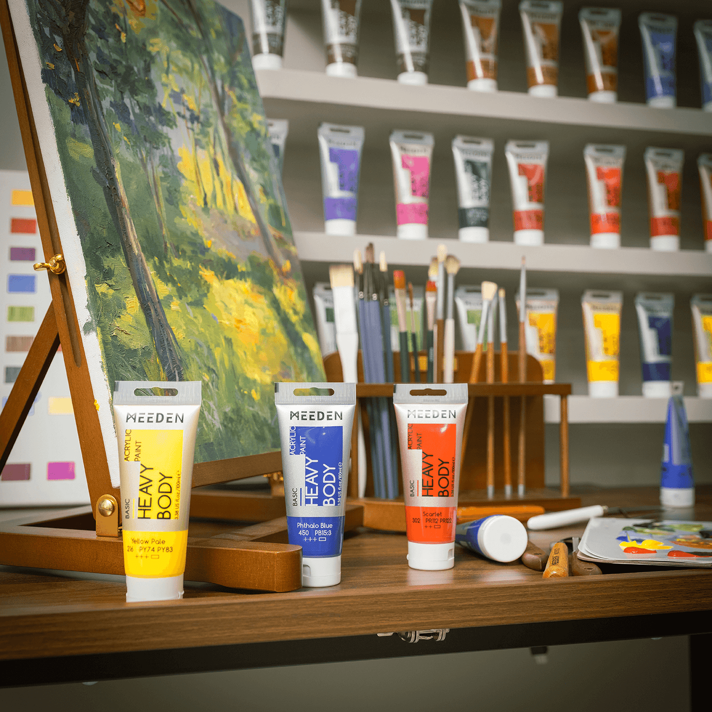 MEEDEN 100ml acrylic paint tubes arranged beside a studio easel