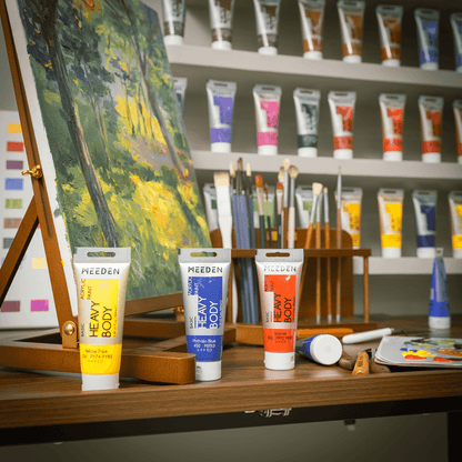 MEEDEN 100ml acrylic paint tubes arranged beside a studio easel