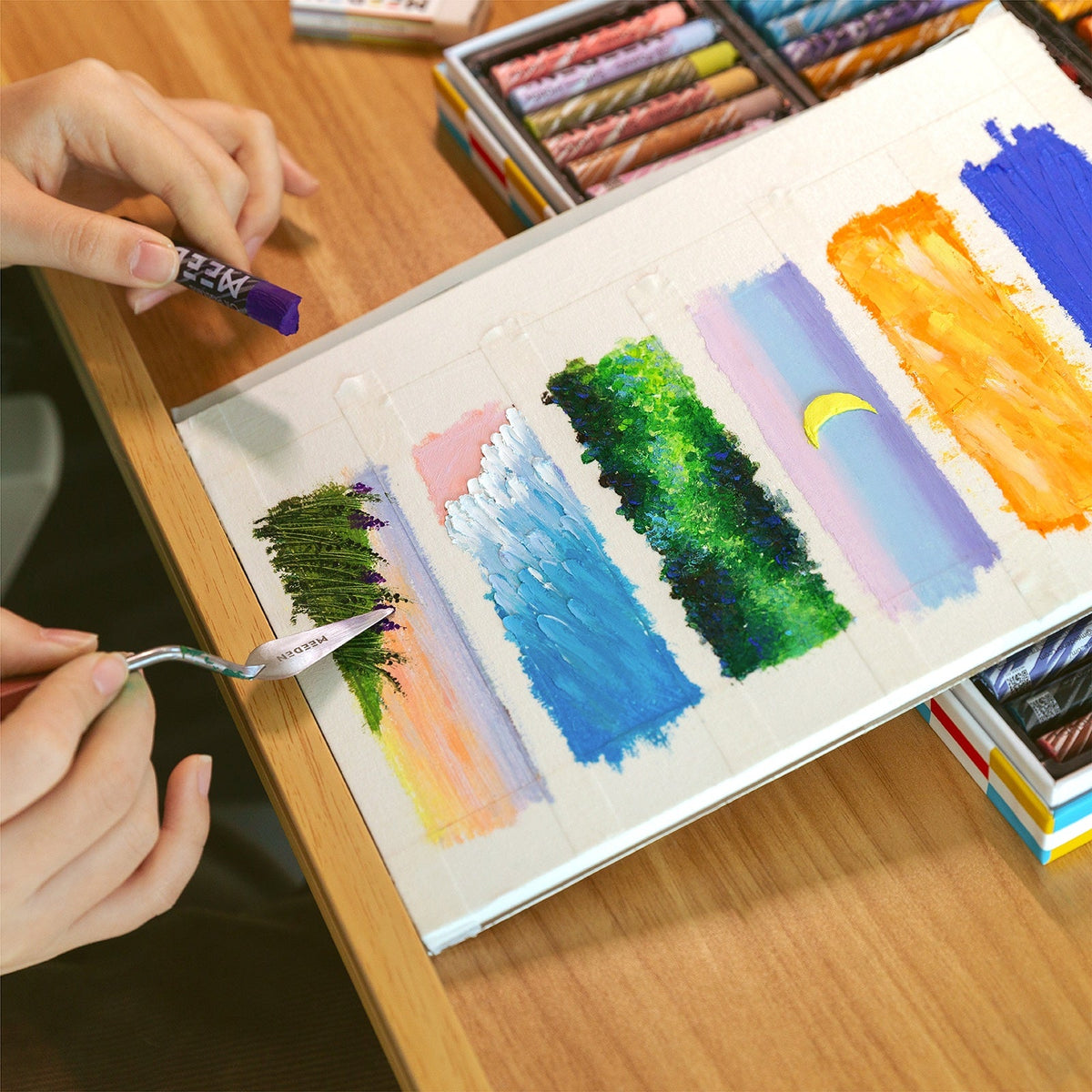 Artist blending colour swatches using the MEEDEN 72-colour pastel set